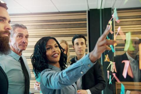 Colleagues working on a sticky note board